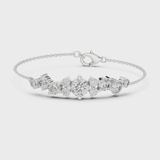 Graduating cluster chain bracelet with baguette and round stone centre detailing