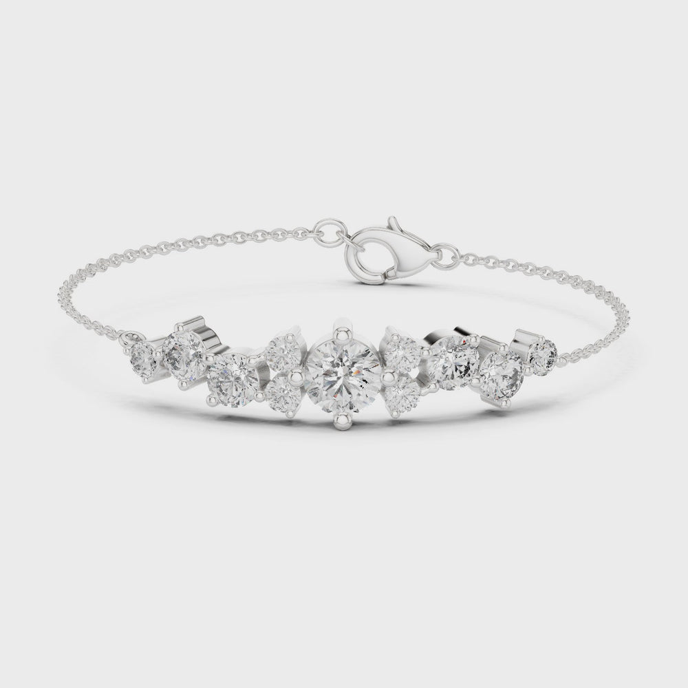 Graduating cluster chain bracelet with baguette and round stone centre detailing