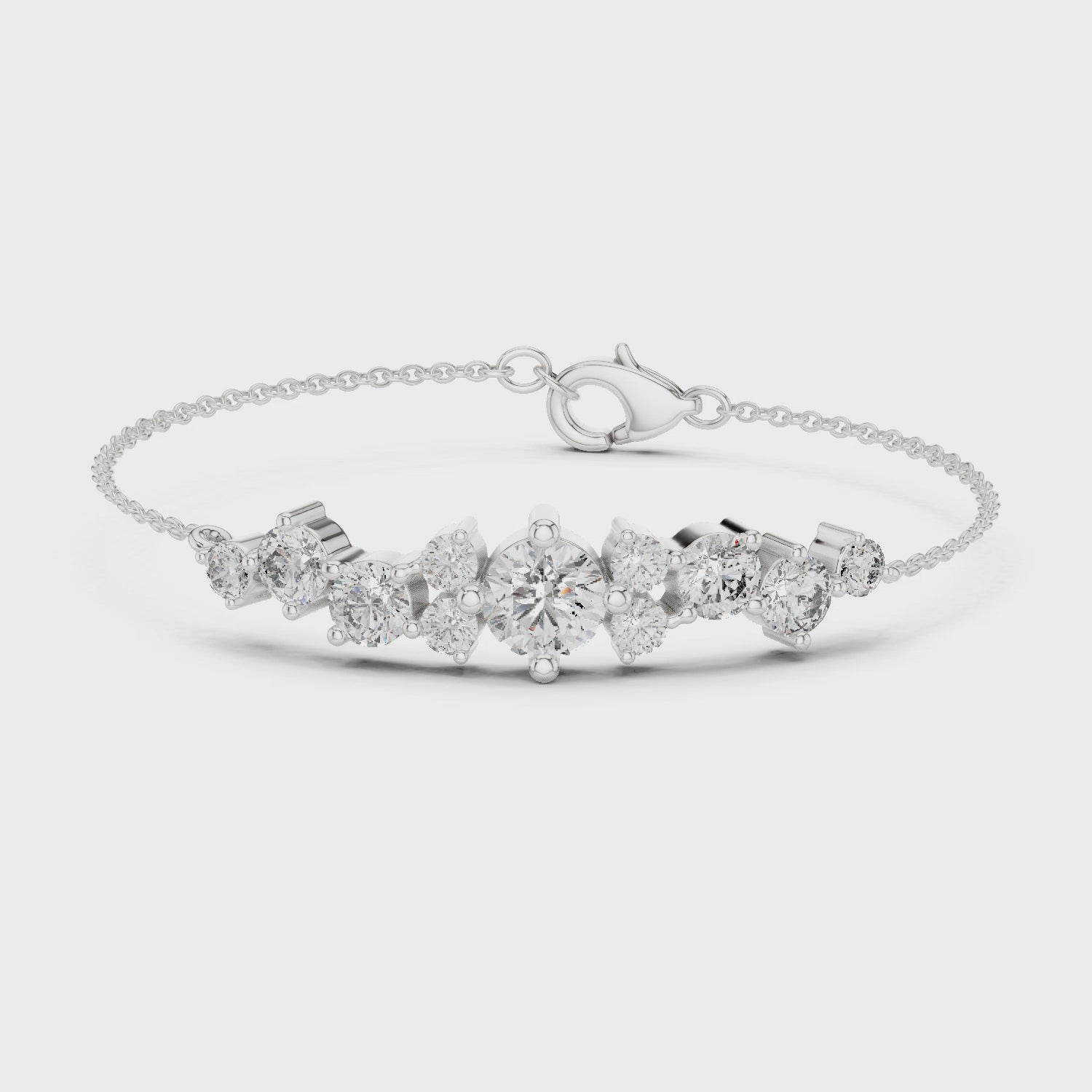 Graduating cluster chain bracelet with baguette and round stone centre detailing