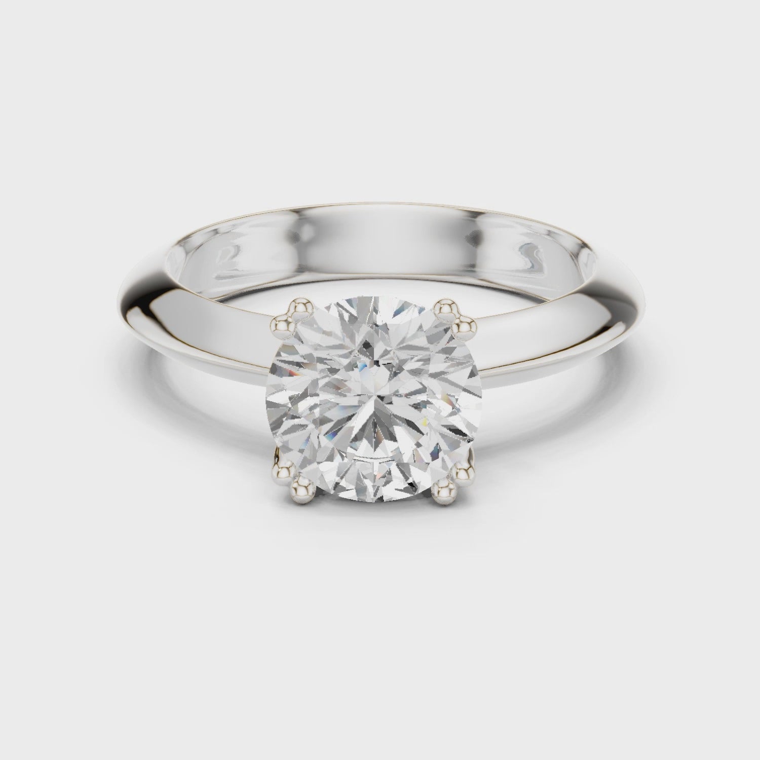 Classic round solitaire engagement ring with six prong cathedral setting and plain tapered band