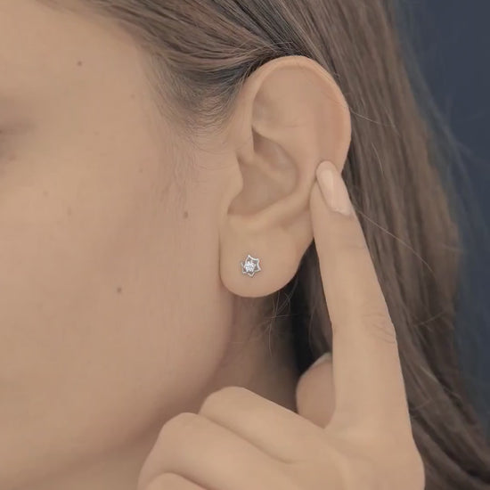 Star burst stud earrings with pointed geometric frame and raised centre