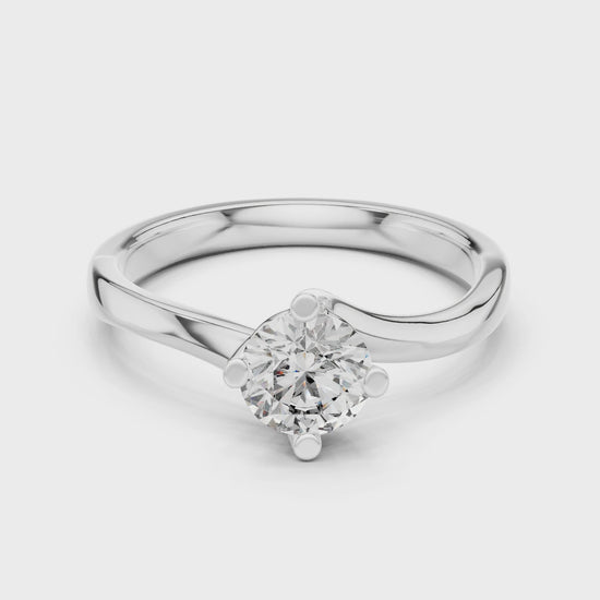 Round solitaire twist engagement ring with four prong setting and flowing bypass band