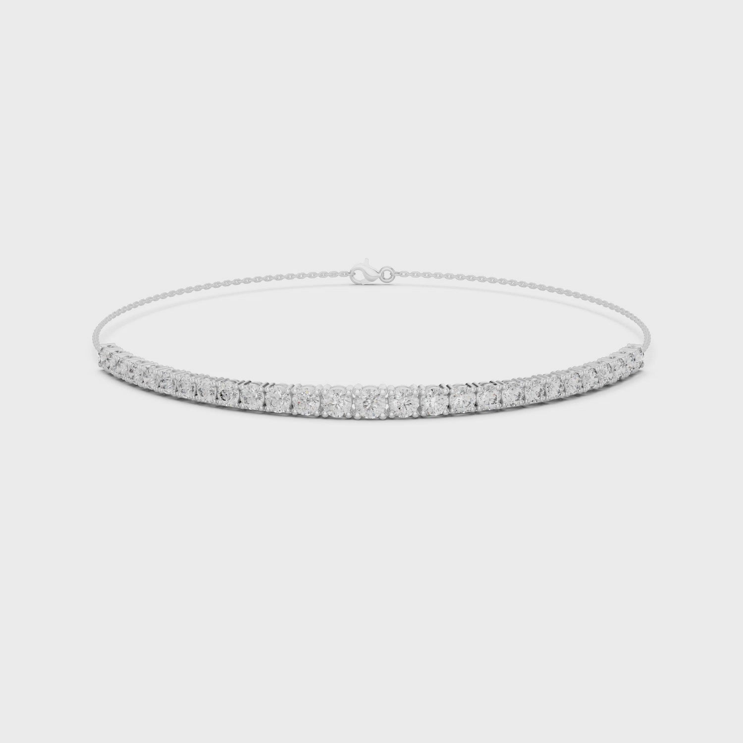 Graduating tennis chain bracelet with prong set round stone row detailing