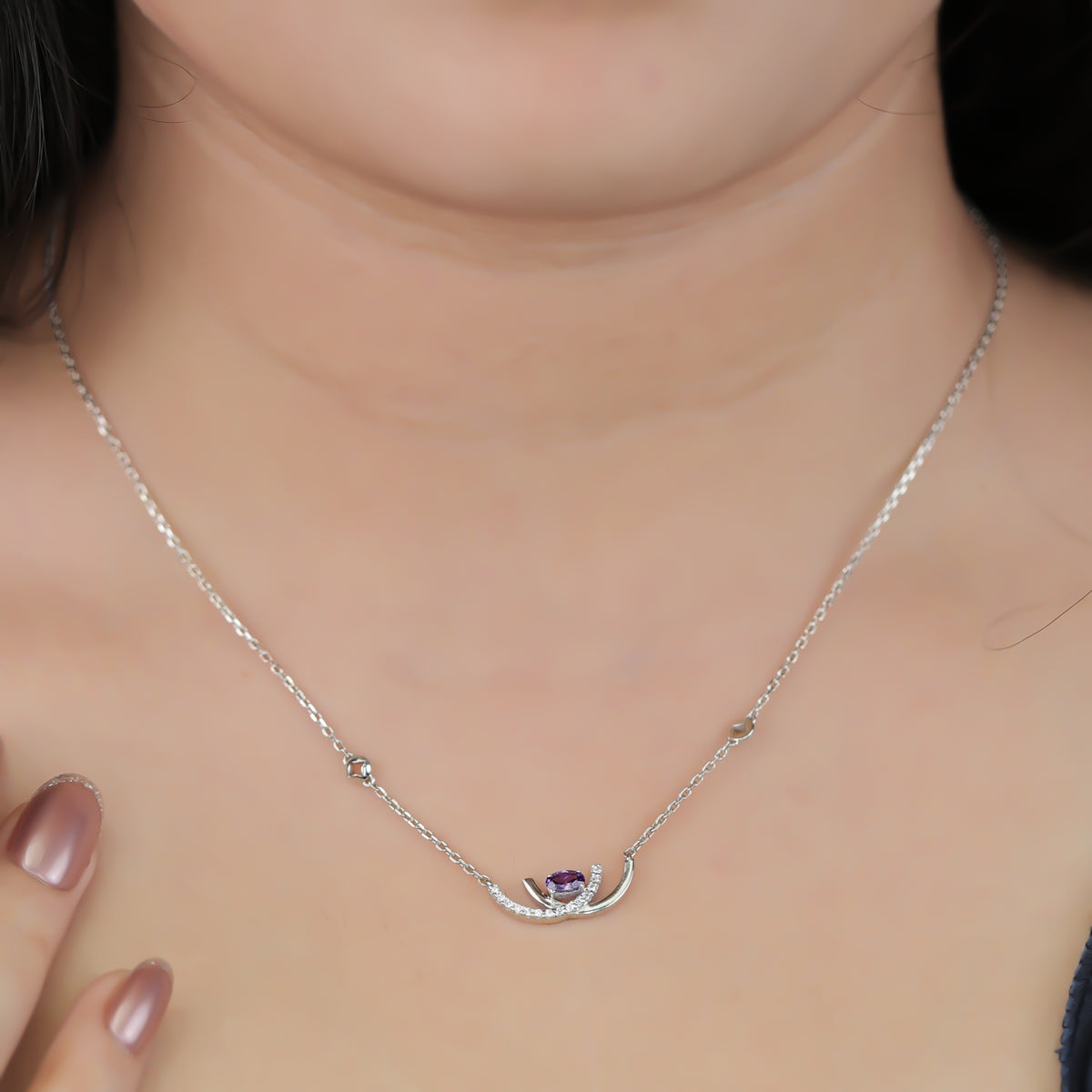 Crescent pendant necklace with a purple stone and delicate silver detailing
