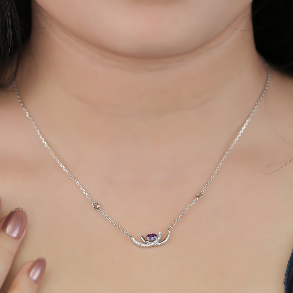 Crescent pendant necklace with a purple stone and delicate silver detailing