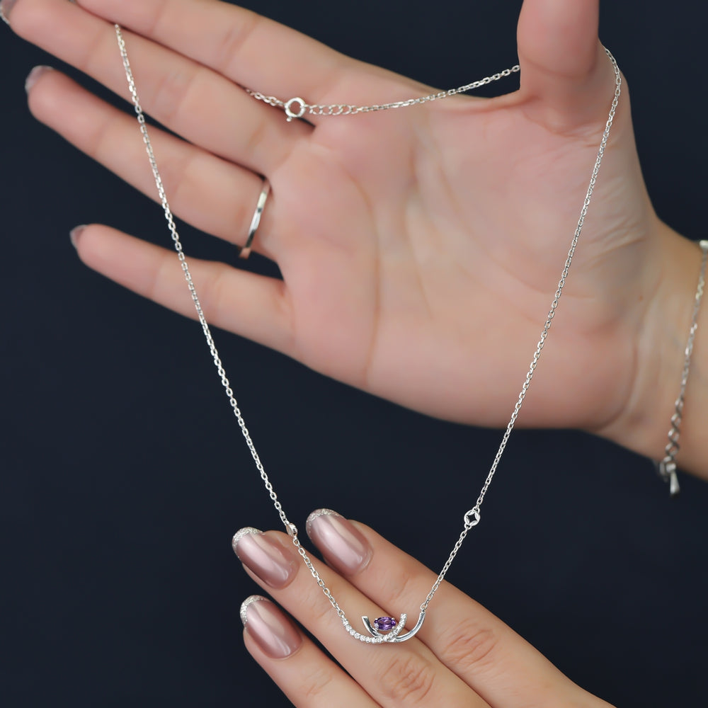 Crescent pendant necklace with a purple stone and delicate silver detailing