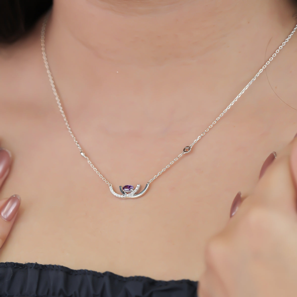 Crescent pendant necklace with a purple stone and delicate silver detailing