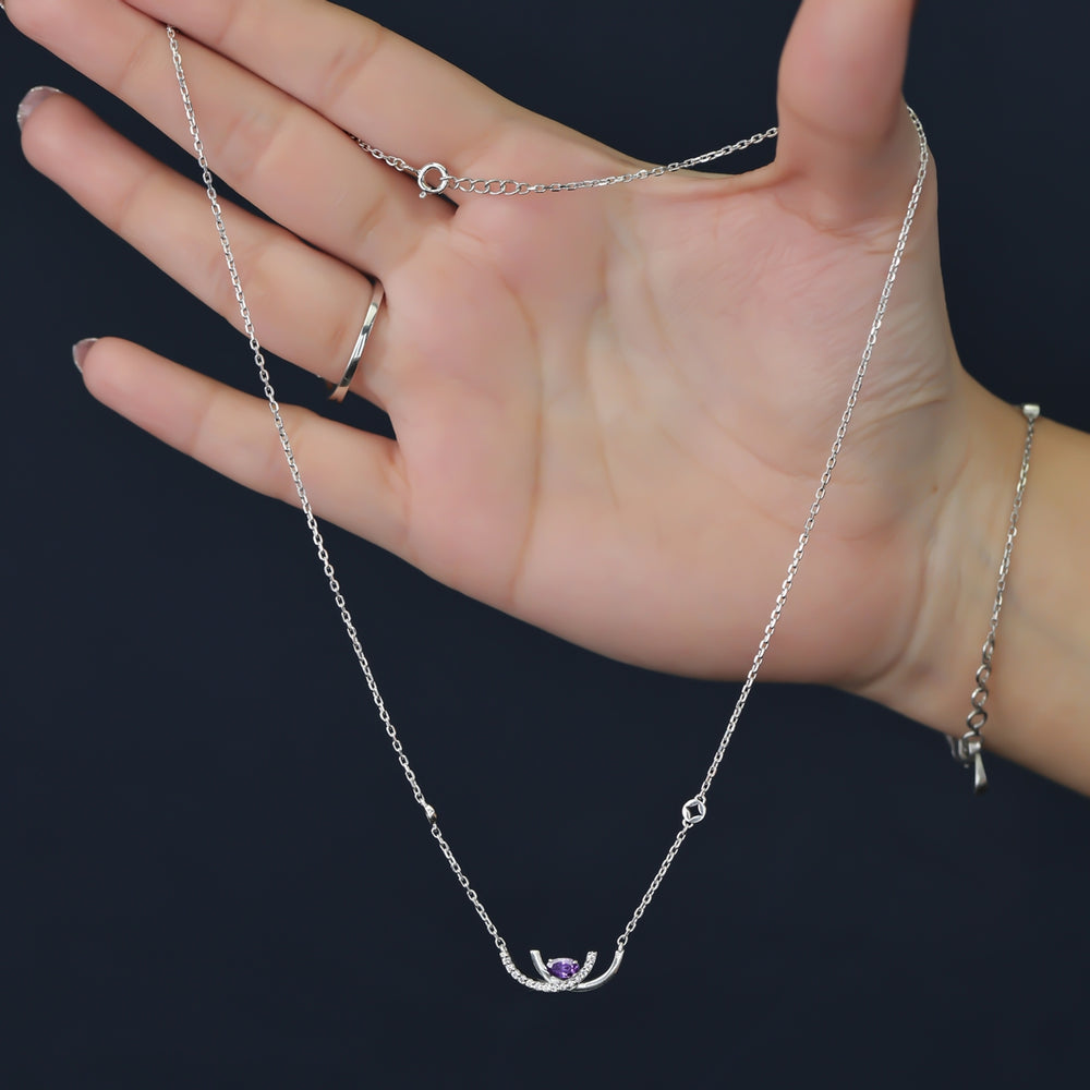 Crescent pendant necklace with a purple stone and delicate silver detailing