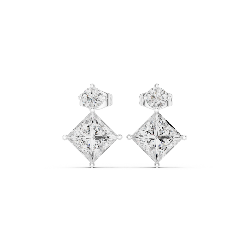 Round brilliant solitaire top with a tilted princess cut stone drop below