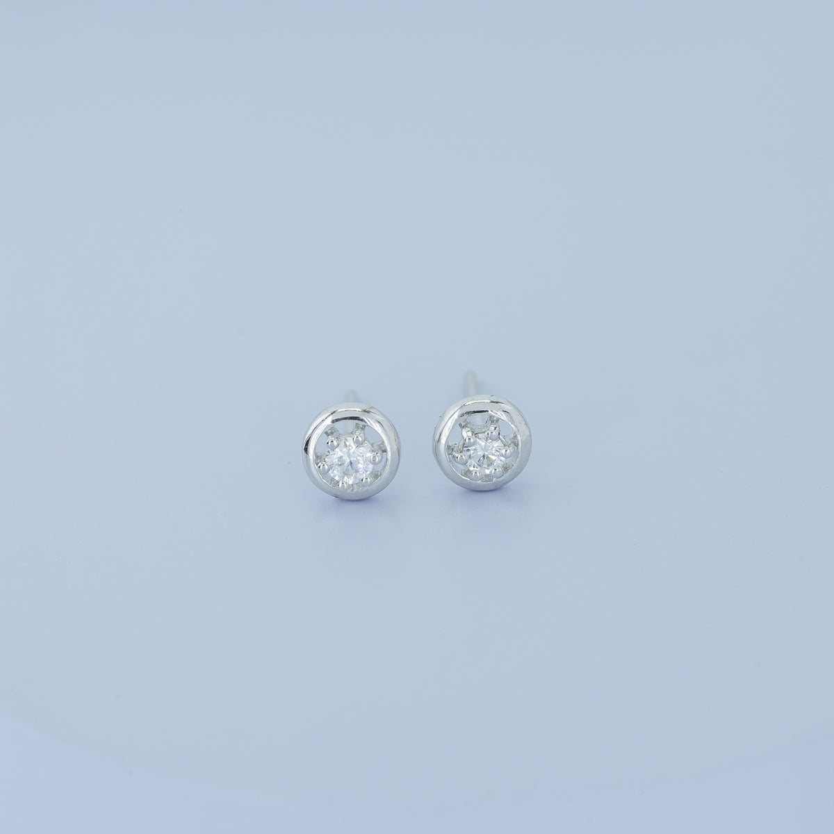 Round halo stud earrings with six claw raised centre and circular border