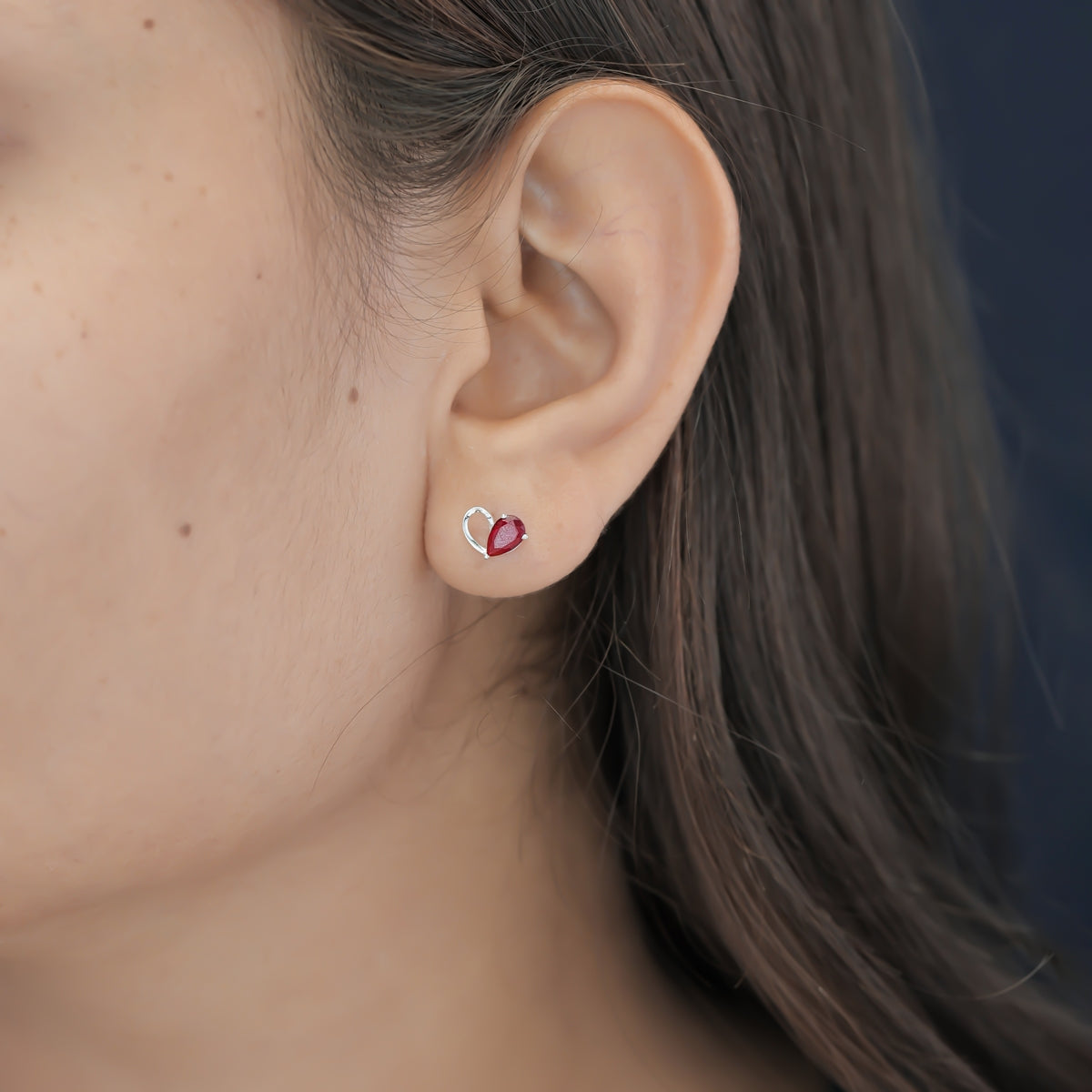 Ruby red heart loop stud earrings with open teardrop swirl base and pear stone top