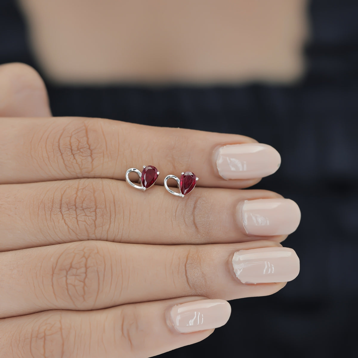 Ruby red heart loop stud earrings with open teardrop swirl base and pear stone top