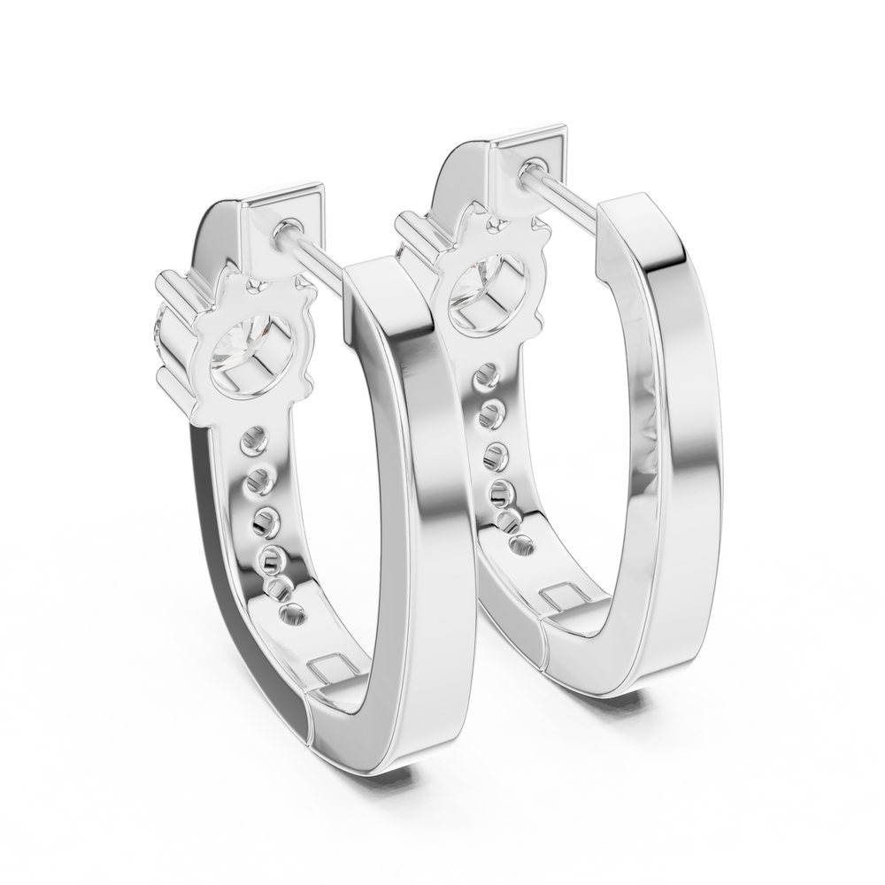 Solitaire station huggie earrings with stone set band and large prong set round solitaire centre stone