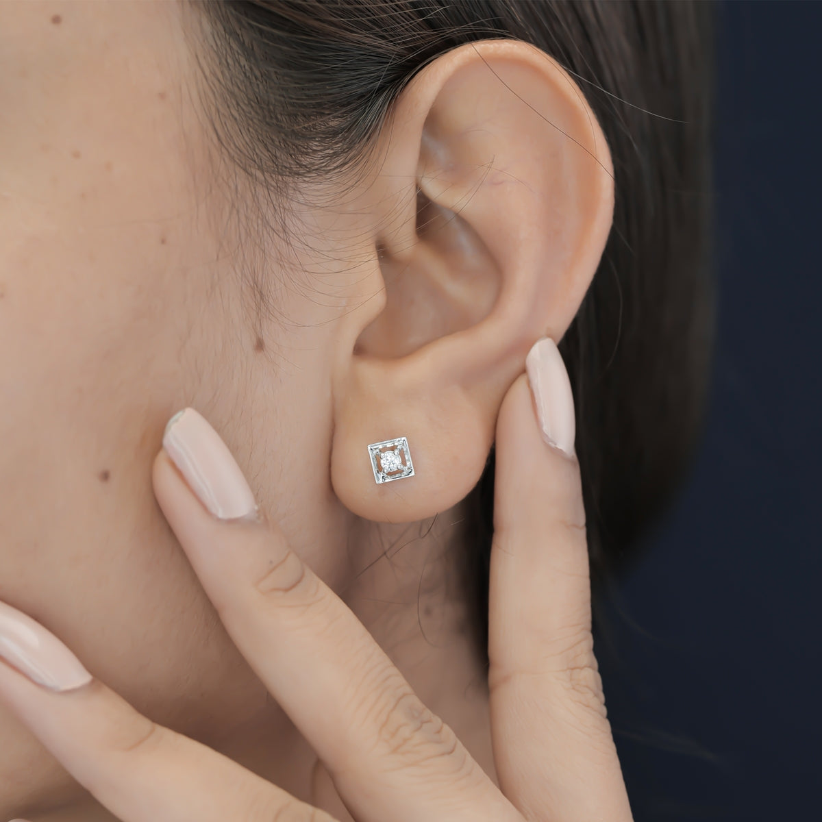 Square claw stud earrings with tilted open frame and raised round centre