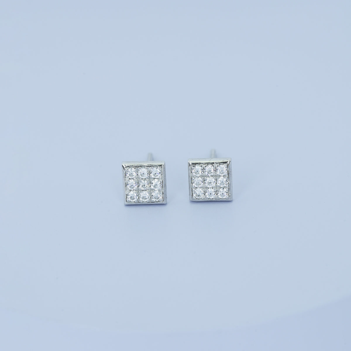 Square grid cluster stud earrings with tilted diamond shape and pave filled surface