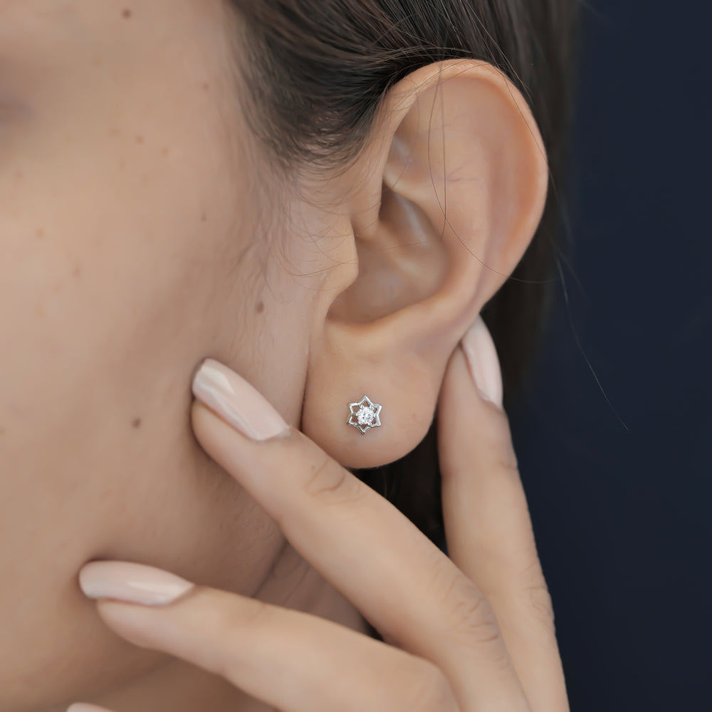 Star burst stud earrings with pointed geometric frame and raised centre