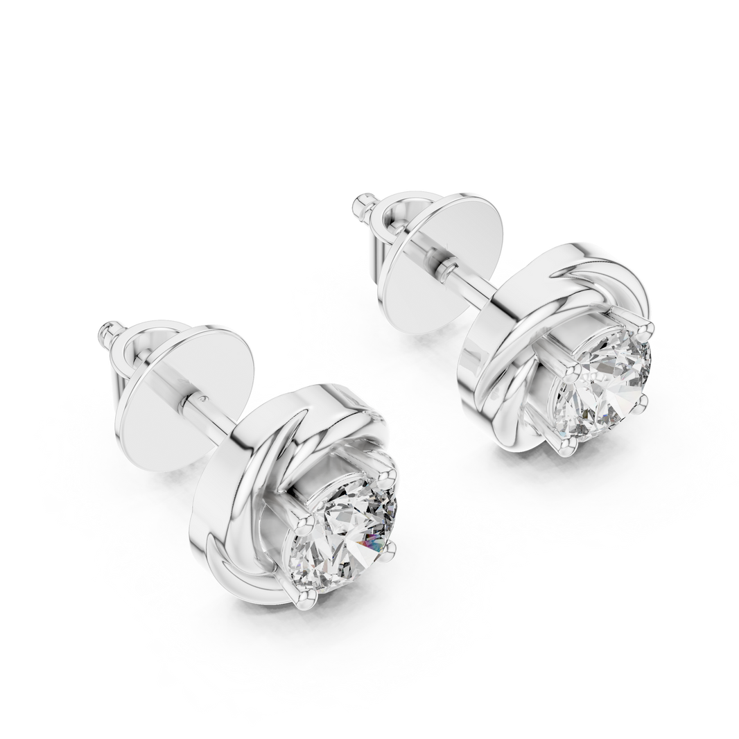 Prong-set round brilliant solitaire stud earrings with a polished swirl surround frame