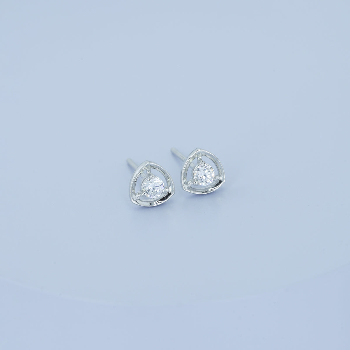 Triangle halo diamond stud earrings with open triangular frame and prong-set round centre stone
