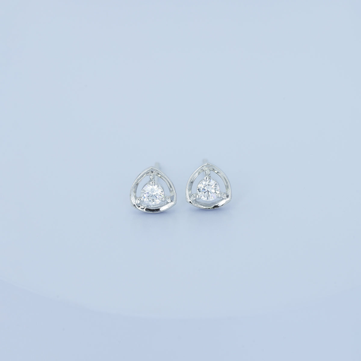 Triangle halo diamond stud earrings with open triangular frame and prong-set round centre stone