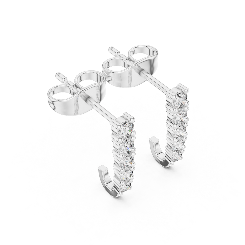 Vertical bar huggie earrings with a straight row of graduating round prong set stones